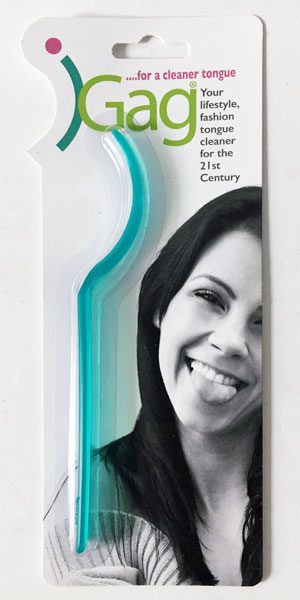 A woman with long hair is holding a toothbrush.